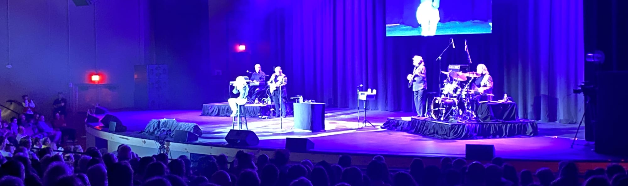 signer on stage in chair washed out by the lights Gainesville