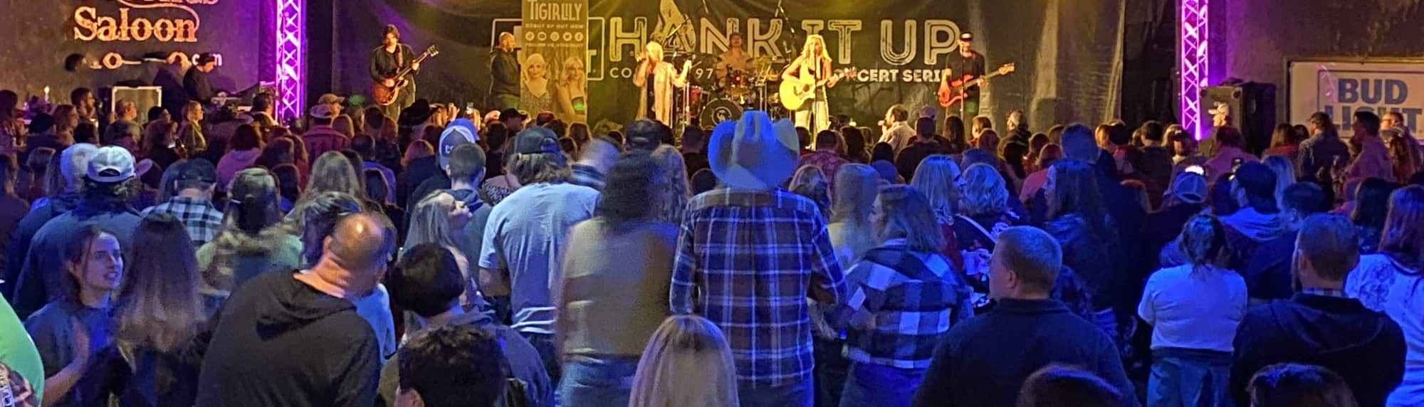 country concert with fans wearing cowboy hats Gainesville